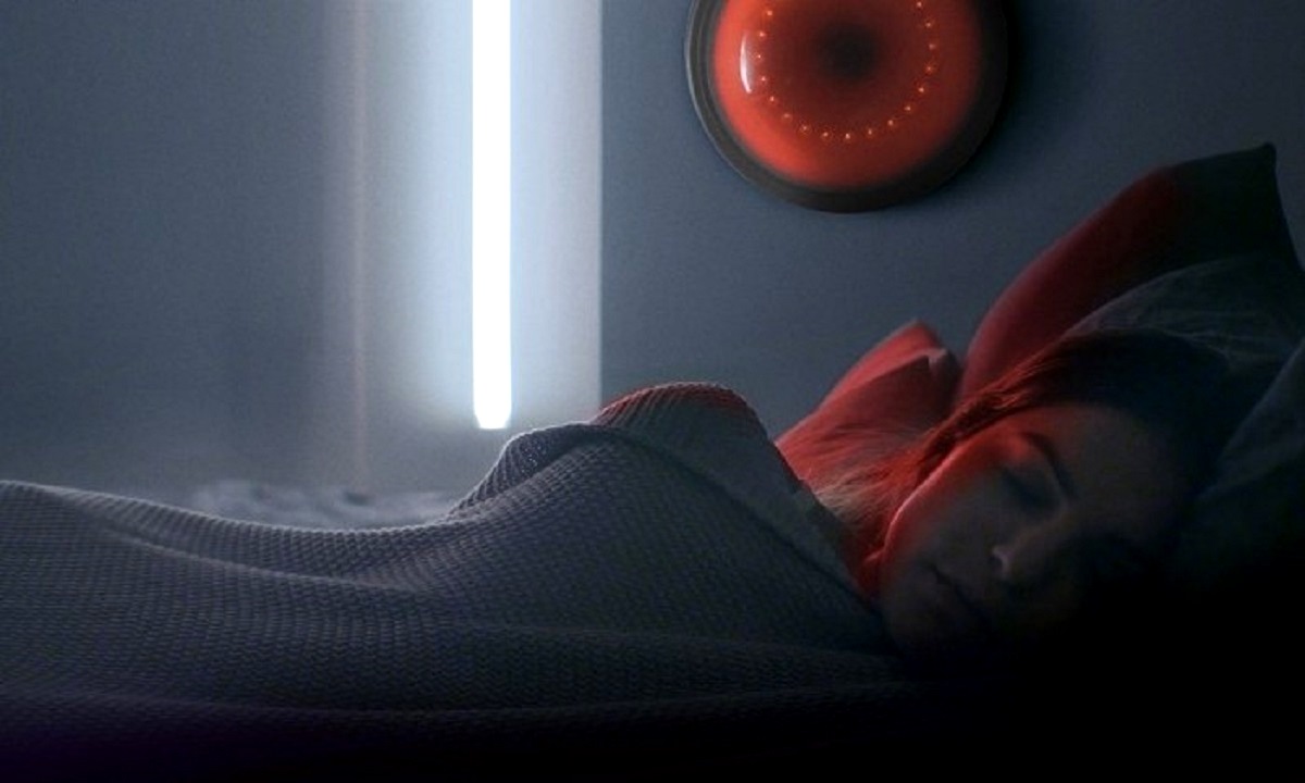 Alexys Gabrielle sleeps as the A.I Aida looks on in Dark Cloud (2022)