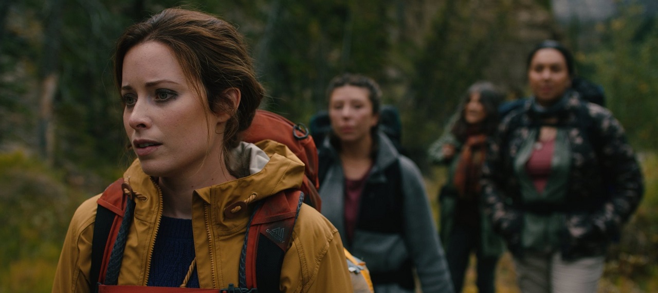 Hannah Anderson, Madison Walsh, Kyra Harper and Roseanne Supernault on a wilderness hike in Dark Nature (2022)