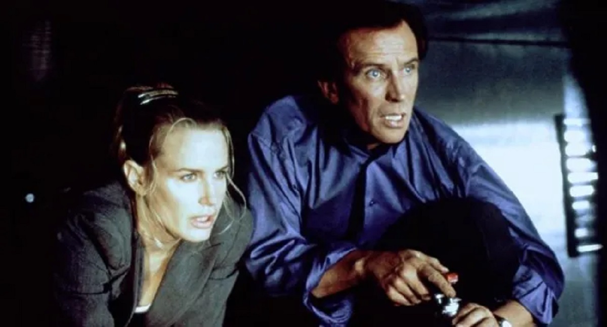 Daryl Hannah and Peter Weller in Diplomatic Siege (1999)