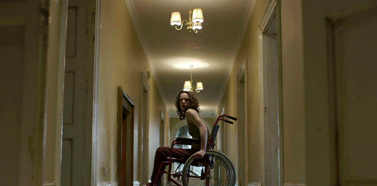 Amy Manson in a wheelchair in Estranged (2015)