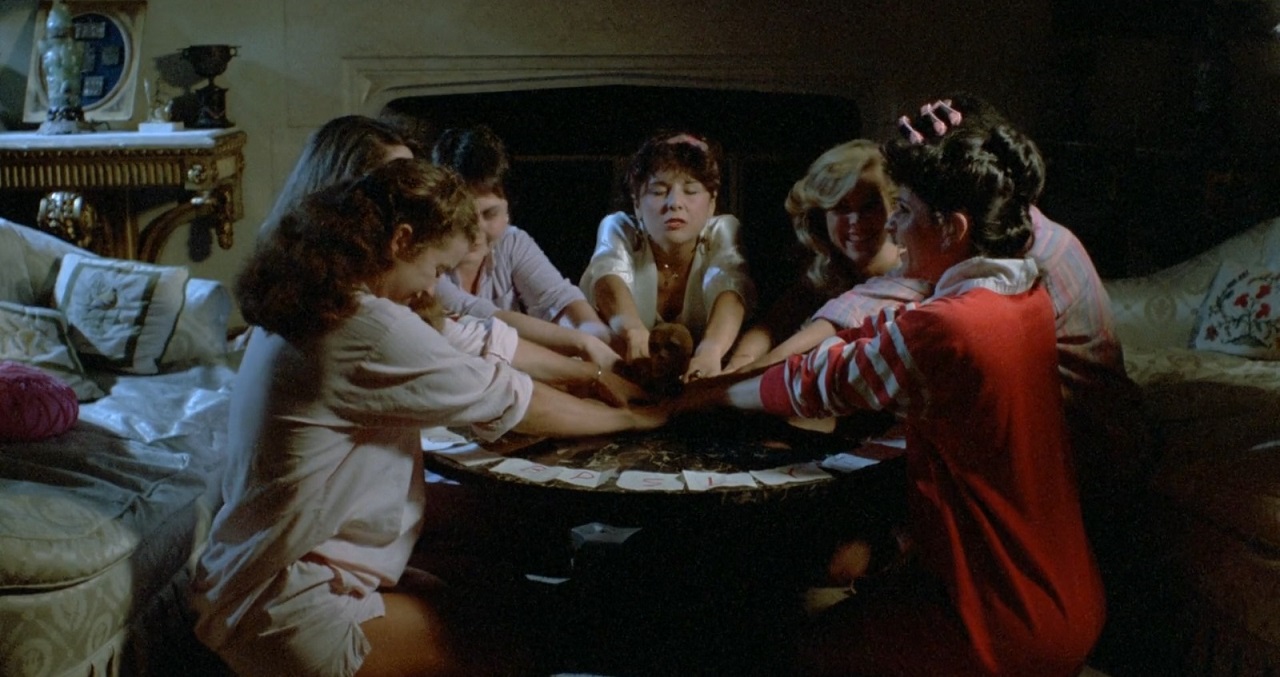 The schoolgirls hold a seance in Girls School Screamers (1985)
