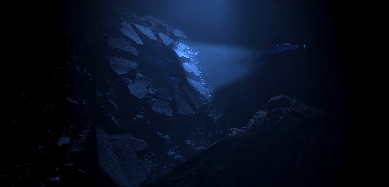 The submarine ventures through the stone portal on the ocean floor in Gods of the Deep (2023)
