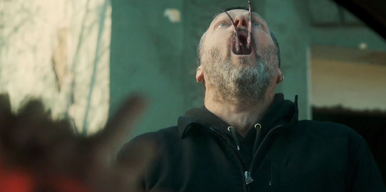 John Adams is taken over by the parasite in Hell Hole (2024)