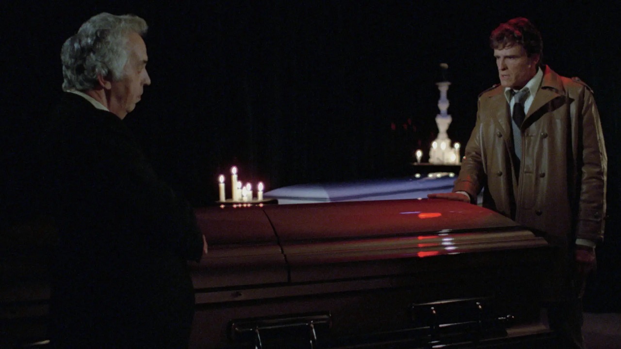 The Mortician (Ivor Francis) tells stories to John Ericson in The House of the Dead (1978)