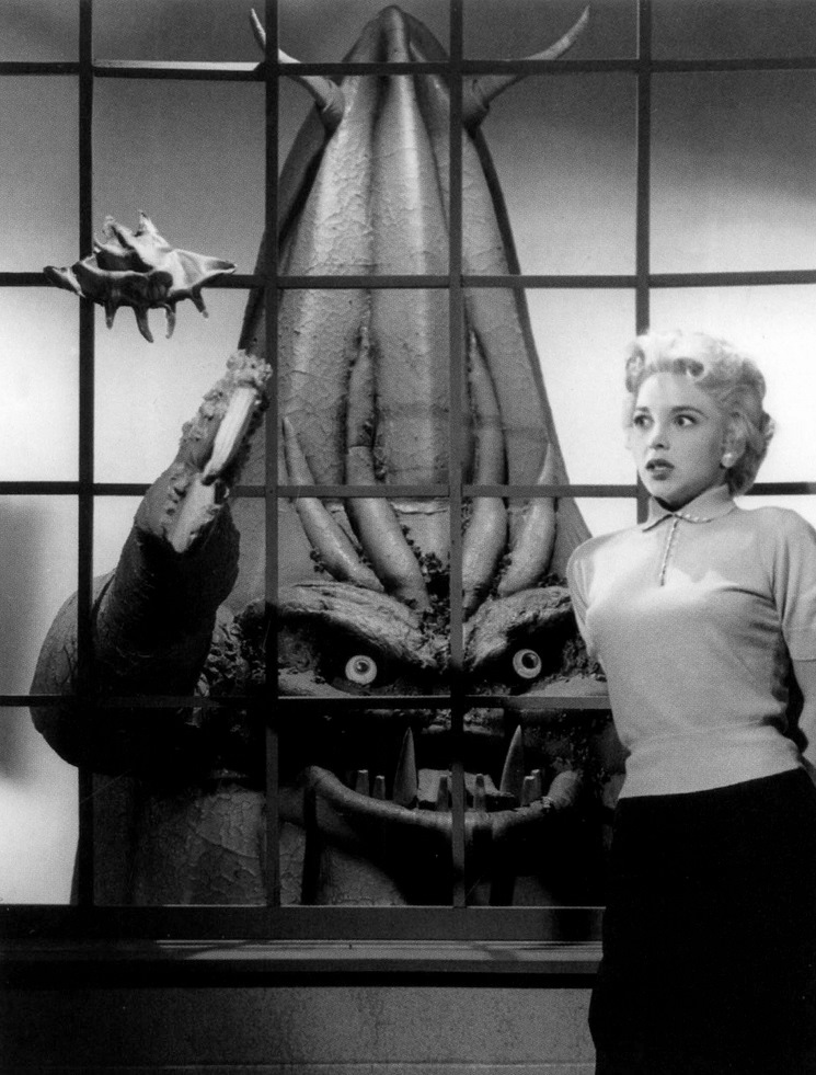 Beverly Garland menaced by the invading alien creature. 