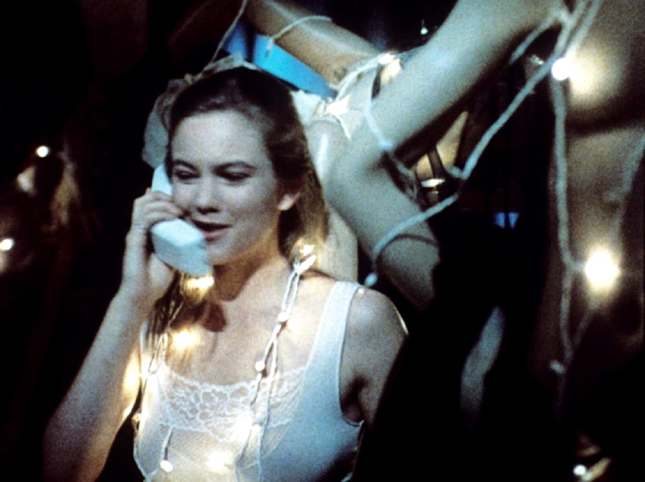 Diane Lane answers the phone surrounded by mannequins in Lady Beware (1987)