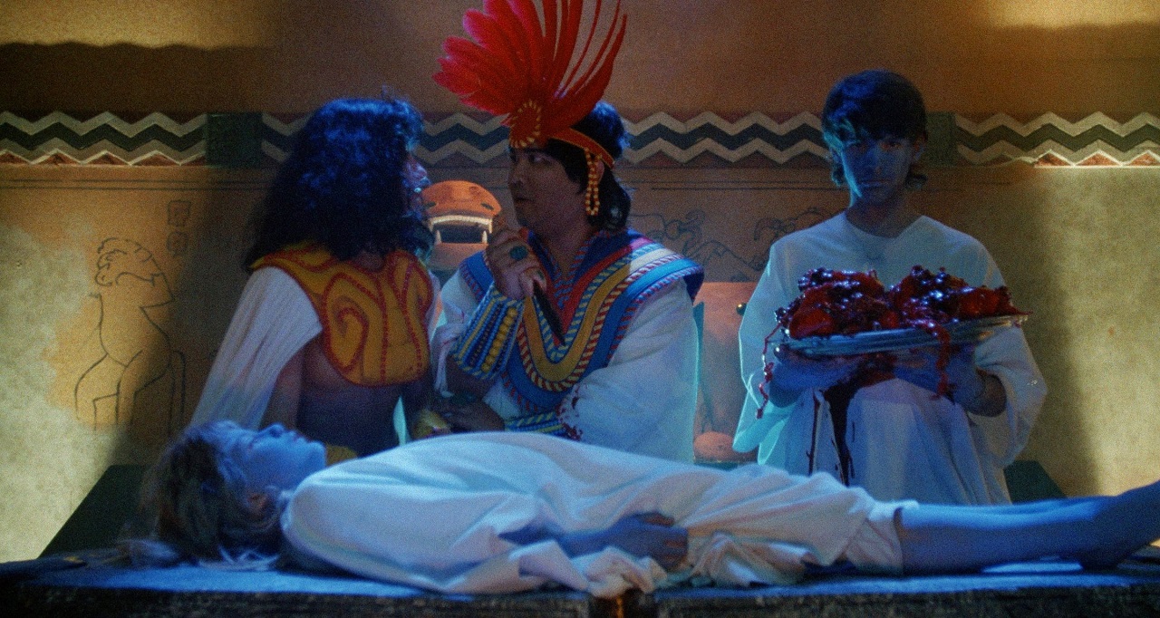 The high priest Dr Um-tzec (S.P. Somtow) conducts an Aztec sacrifice in The Laughing Dead (1989)