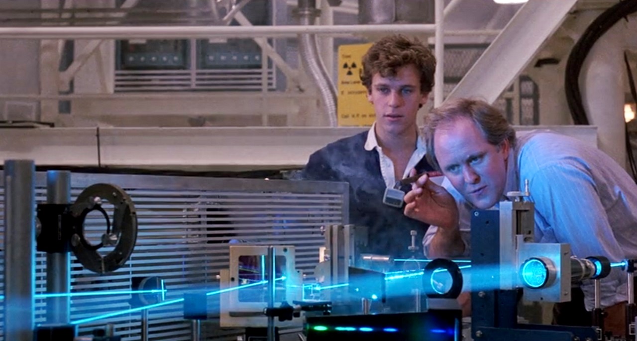 John Lithgow demonstrates a laser to Christopher Collett in The Manhattan Project (1986)