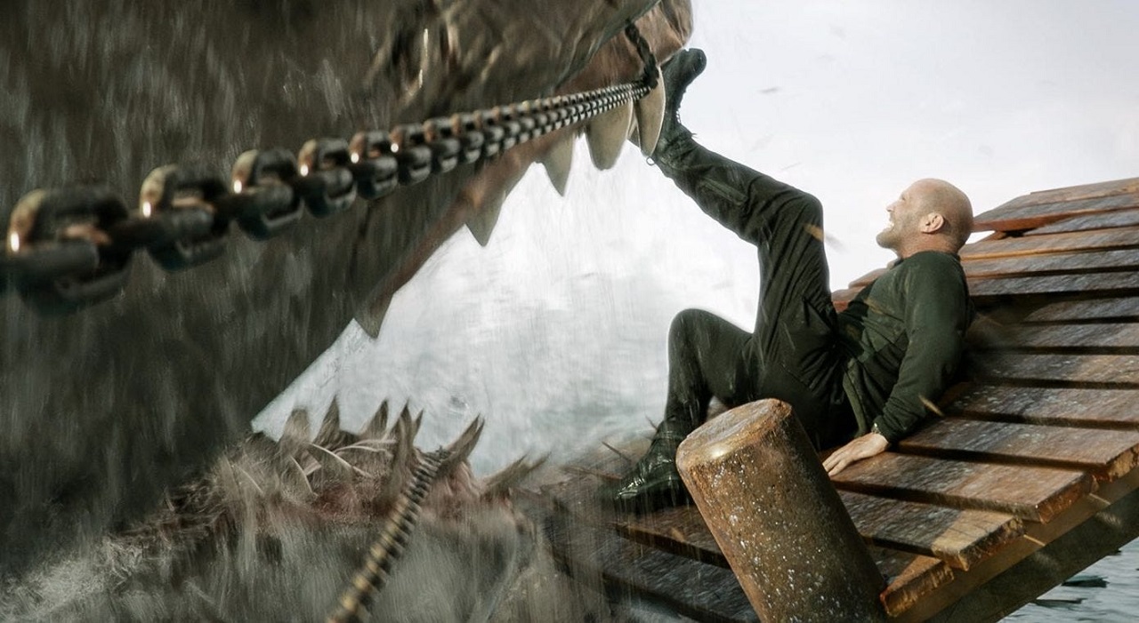 Jason Statham fights off the megalodon on a jetty in Meg 2: The Trench (2023)