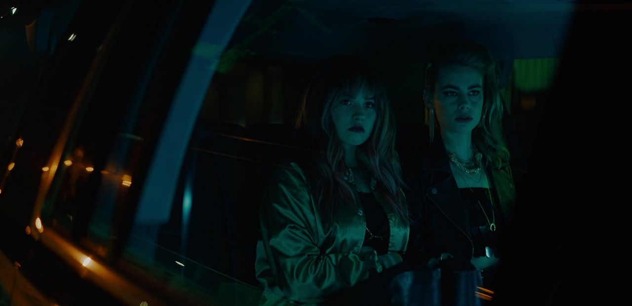 Vampire girls Debby Ryan and Lucy Fry on a limousine ride through L.A. in Night Teeth (2021)