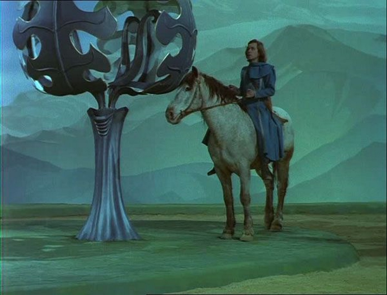 Fabrice Luchini as Perceval travels through the beaten metal trees in Perceval le Gallois (1978)
