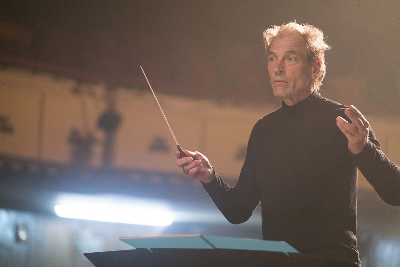 Julian Sands  as the conductor Gustafson in The Piper (2023)