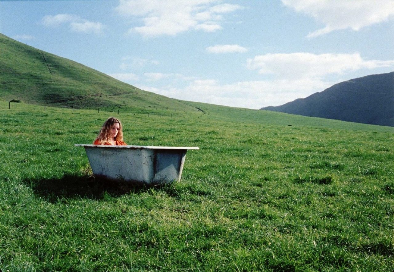 Danielle Cormack takes a bath in the field in The Price of Milk (2000)