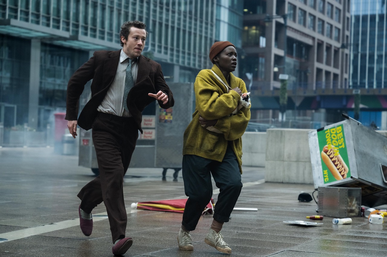 Joseph Quinn and Lupita Nyong’o flee through the mass destruction in A Quiet Place: Day One (2024)