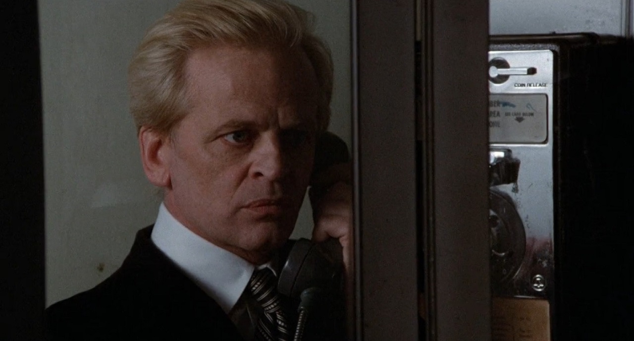 Klaus Kinski as psychologist Pieter Fales in a phone booth in Schizoid (1980)