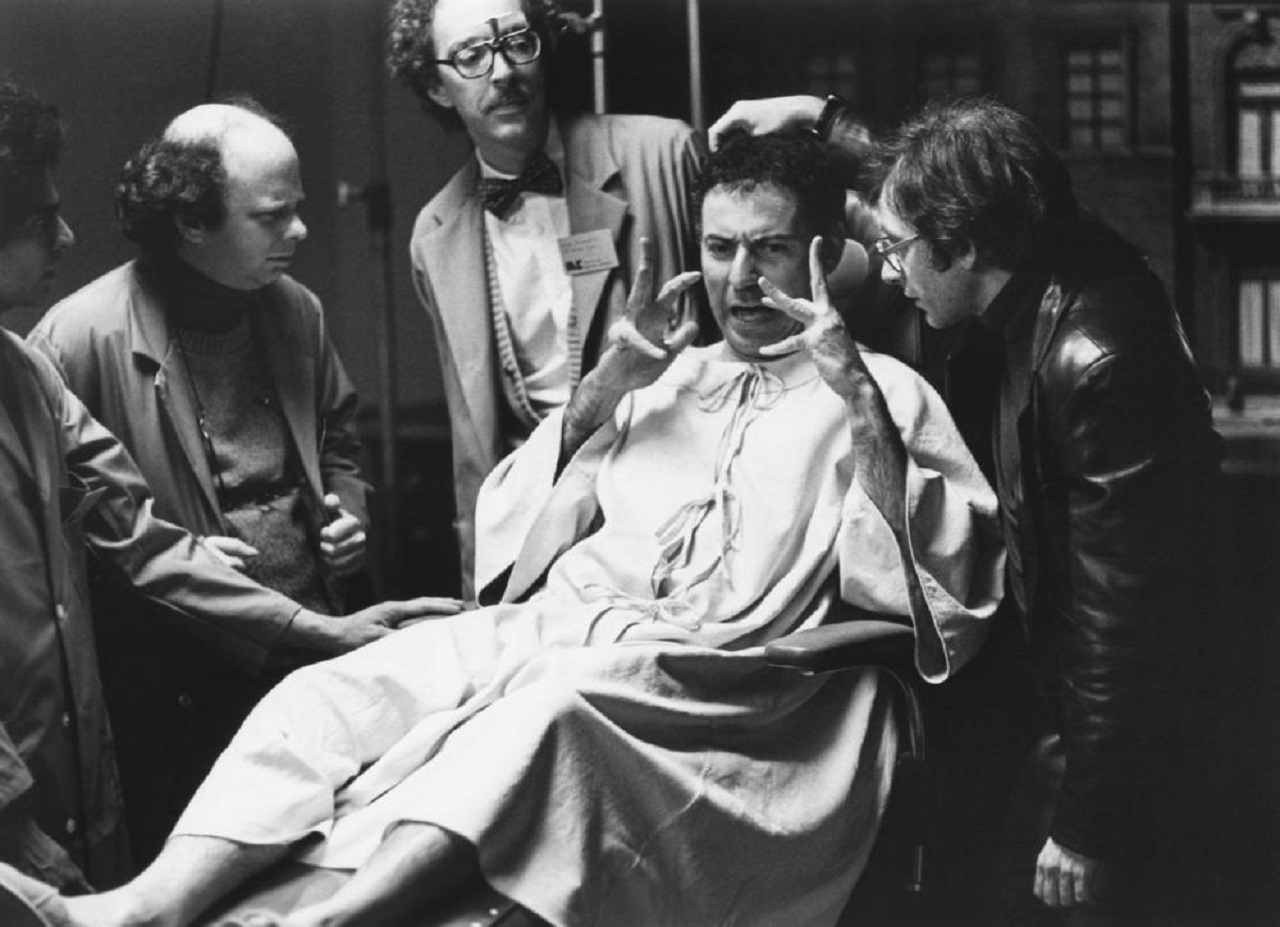 Simon Mendelssohn (Alan Arkin) surrounded by scientists Wallace Shawn, William Finley and Austin Pendleton in Simon (1980)