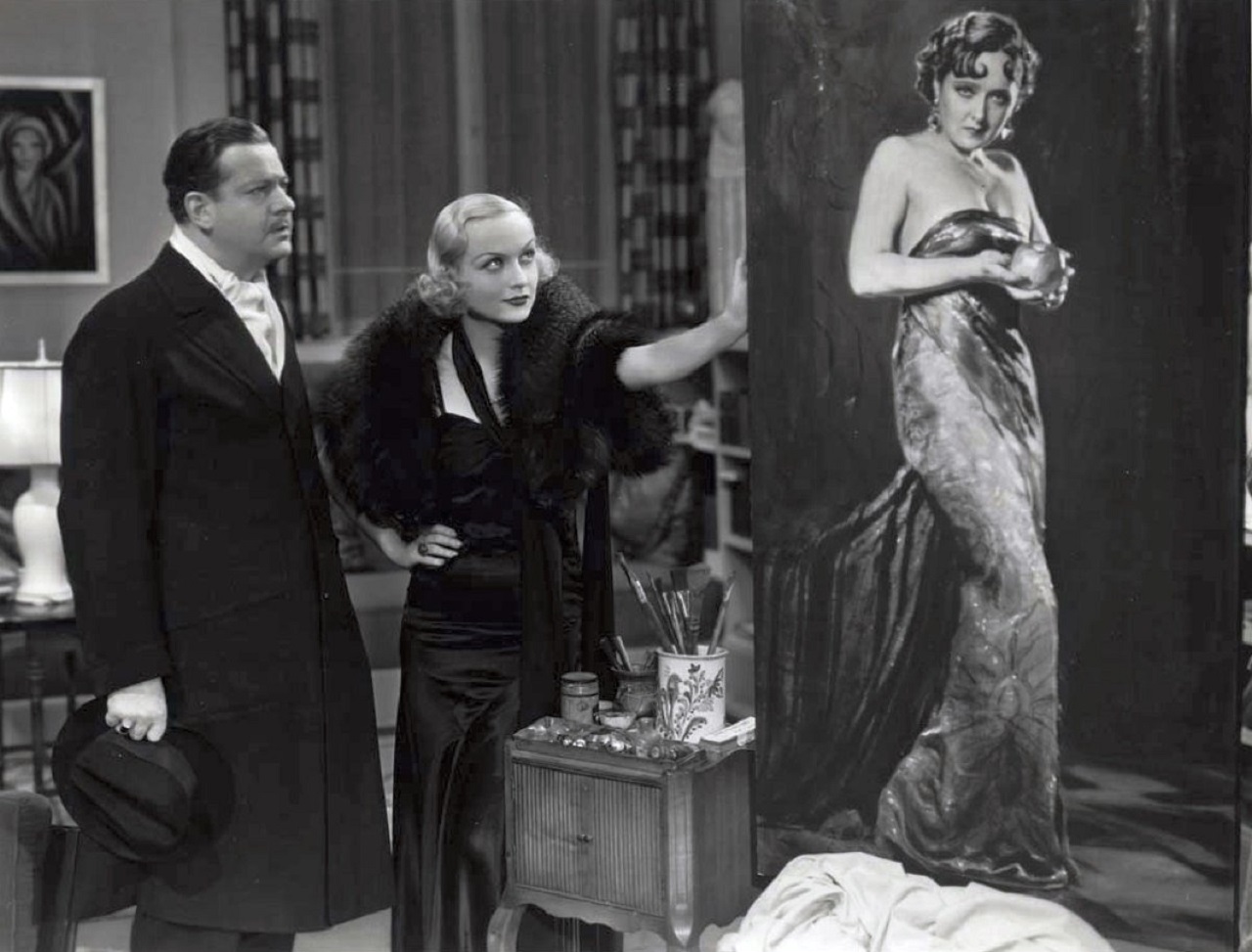 Carole Lombard shows H.B. Warner her portrait of executed murderess Vivienne Osbourne in Supernatural (1933)