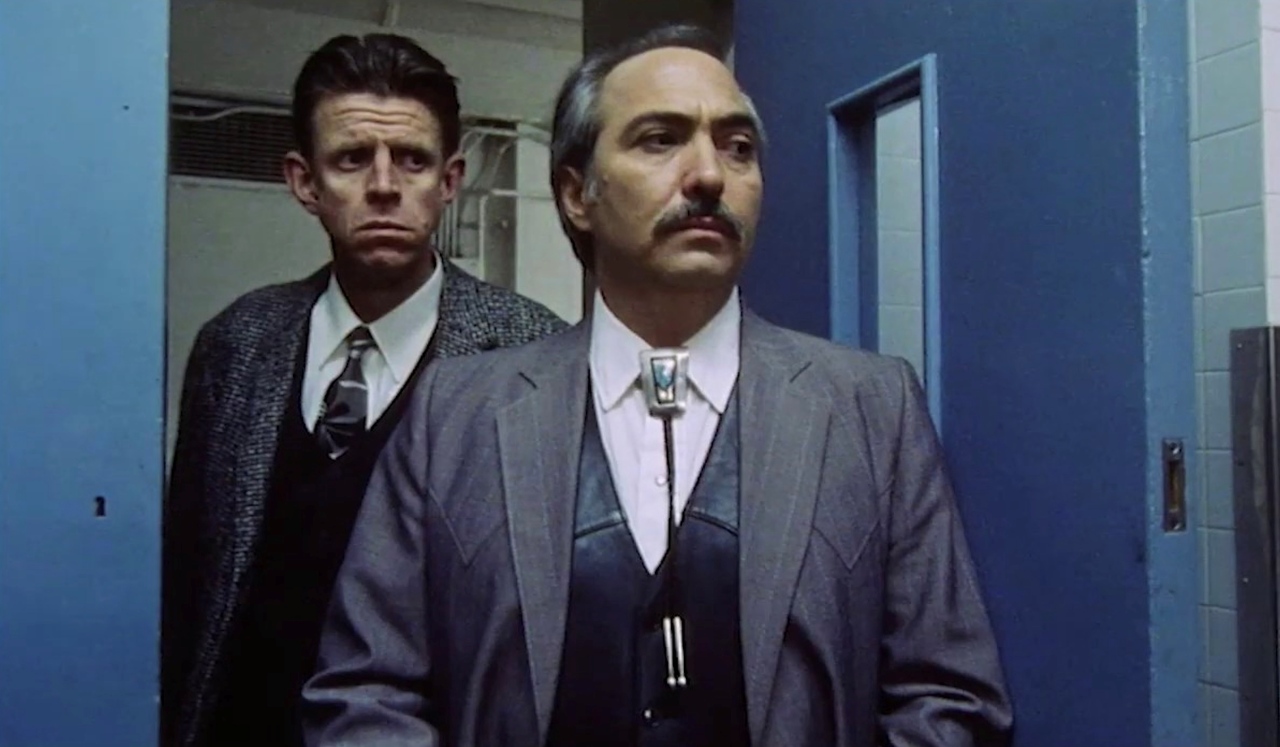 Alex Cox and Miguel Sandoval in Three Businessmen (1998)