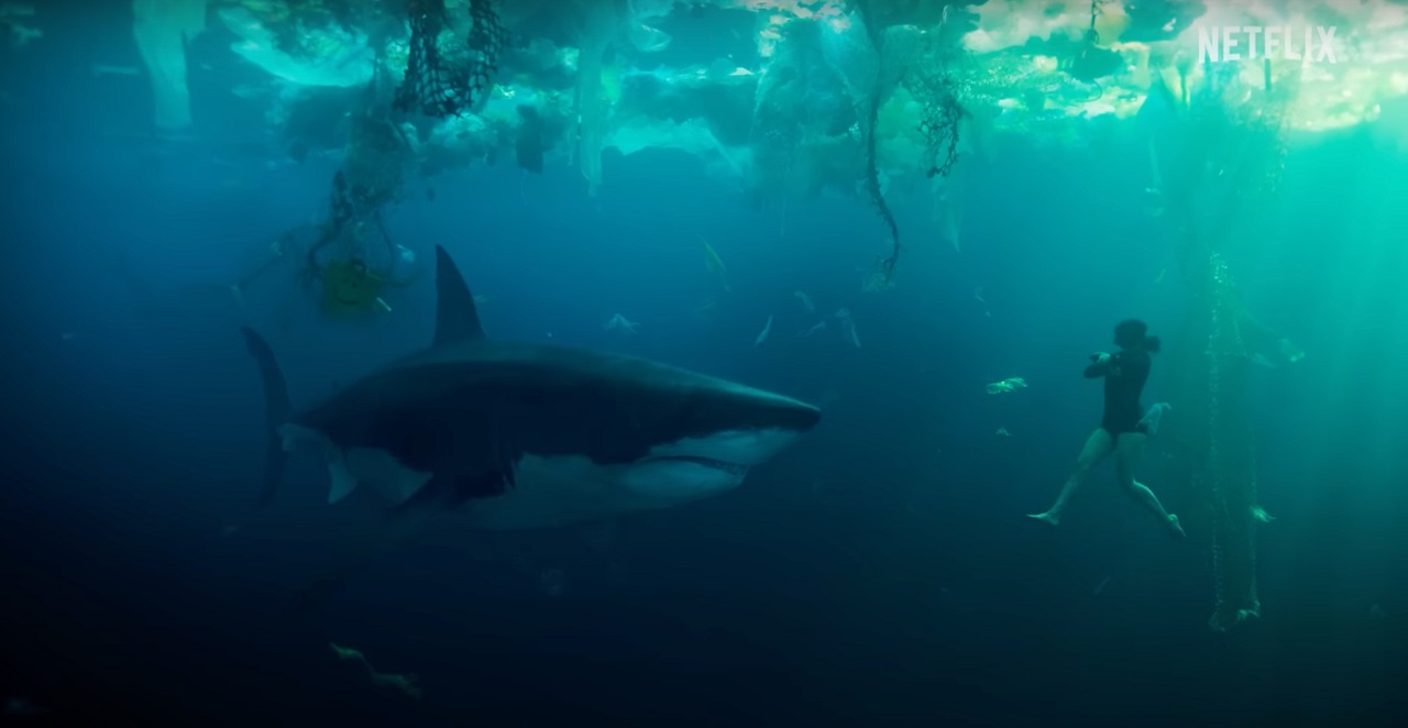 Berenice Bejo and Lilith the shark under the floating sea of plastic in Under Paris (2024)