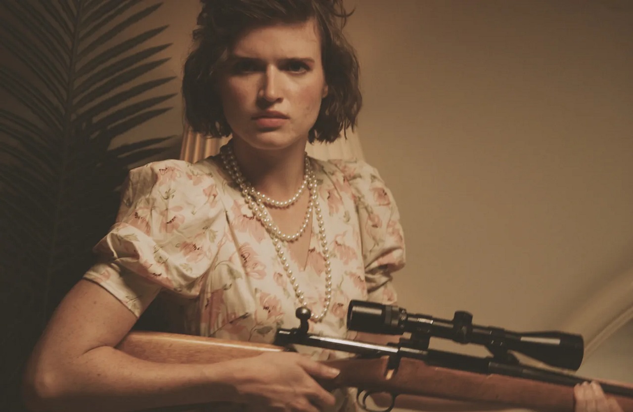 Evie Bair goes hunting people with a sniper rifle as part of a ritual in the Ambrosia episode of V/H/S/85 (2023)