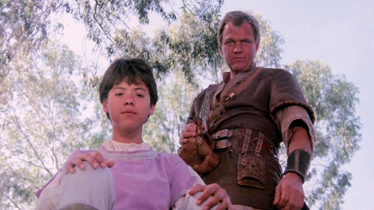 Simon (Vidal Peterson) and Kor the Conqueror (Bo Svenson) in Wizards of the Lost Kingdom (1984)